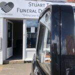 Hearse outside Shop front of Stuart Taylor Funeral Directors Ltd based in Wall Heath.