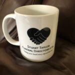 Mug with Stuart Taylor Funeral Directors Ltd Logo on.
